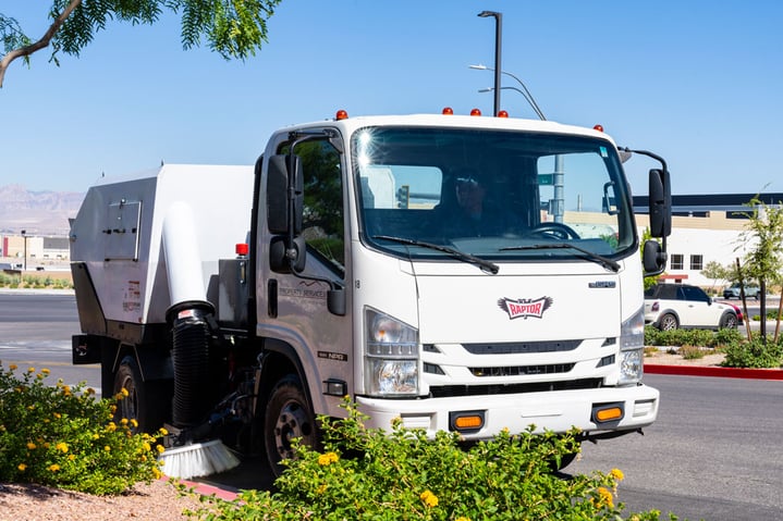 Front view of a sweeper truck from Red Rock Property services