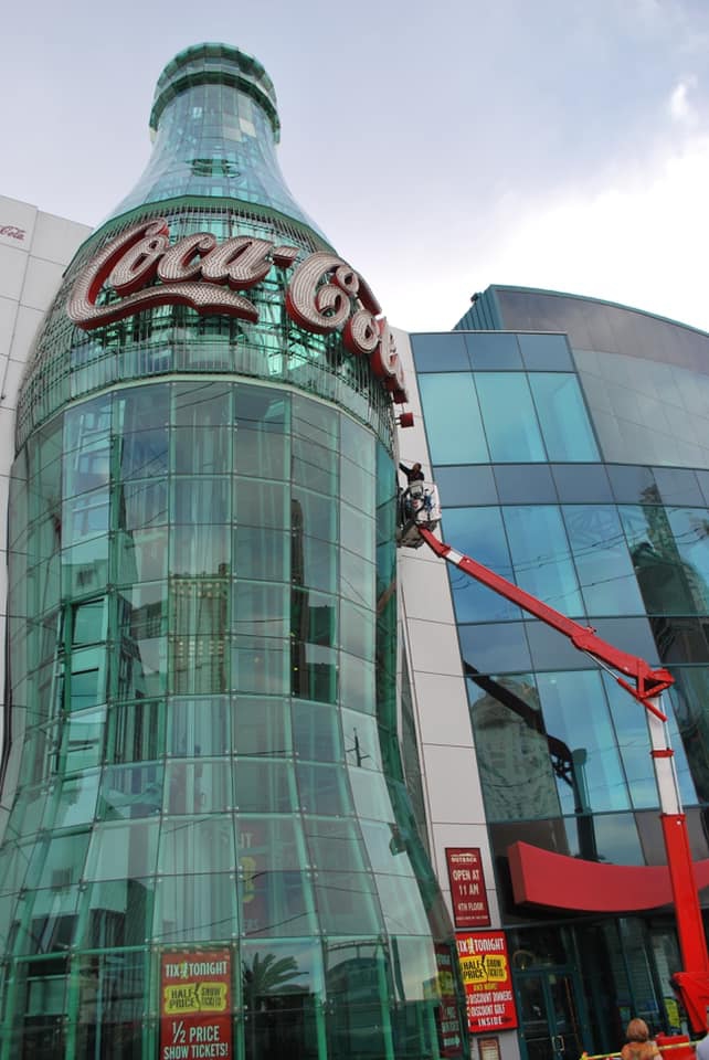 The Red Rock Property Services team in Las Vegas, Nevada cleaning high-rise windows of the Coca-Cola building using an atrium lift. 