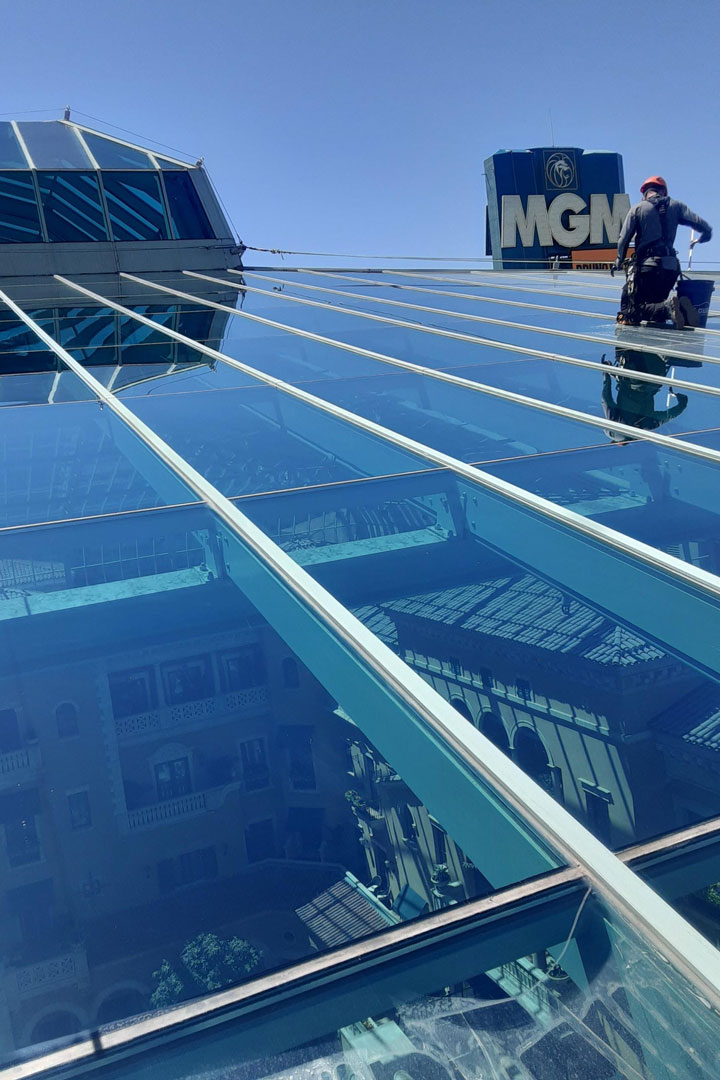 Red Rock Property services team cleaning the high rise atrium window at the MGM Grand Pool in Las Vegas, Nevada
